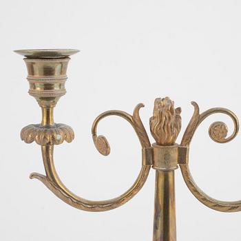 A pair of Swedish Empire two-branch gilt-brass candelabra, 1820's/30's.