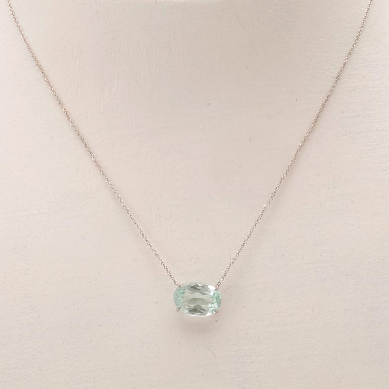 An 18K white gold necklace with an oval faceted aquamarine.