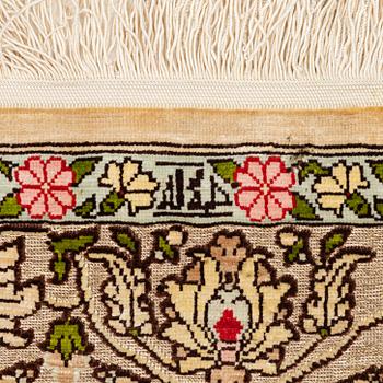 A silk an metal Hereke rug, West Anatolia, c. 100 x 68 cm.