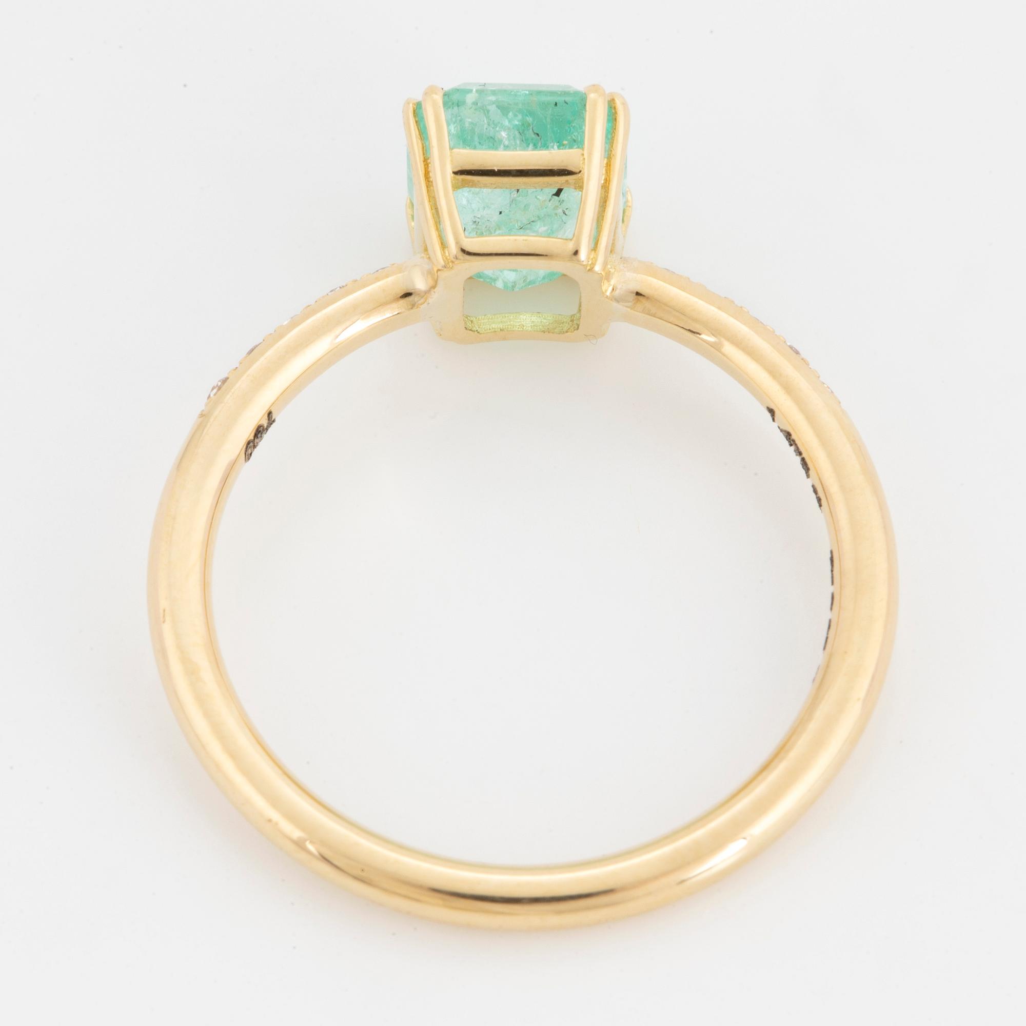 Emerald-cut  pale emerald and brilliant-cut diamond ring.