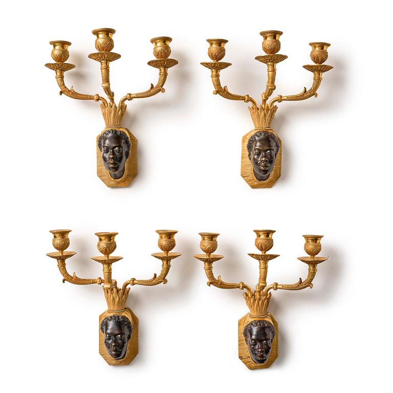 A set of four Empire ormolu and patinated bronze three-branch appliques, Paris, ca 1840's.