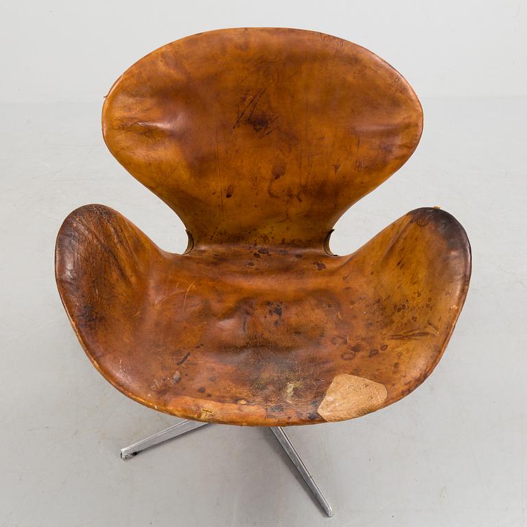 An Arne Jacobsen steel and brown leather 'Swan' chair, Fritz Hansen, Denmark 1960's.