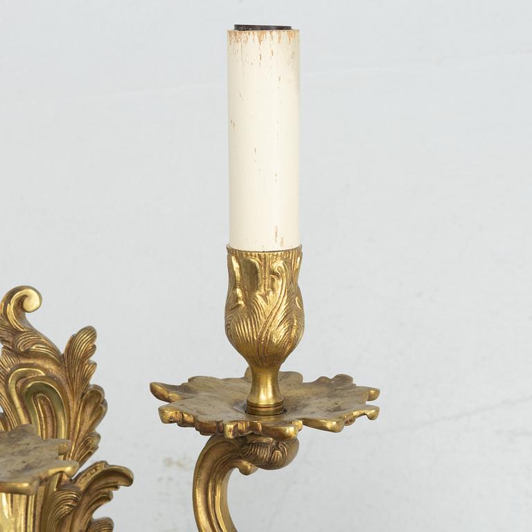 A pair of Rococo style wall lamps, early 20th Century.