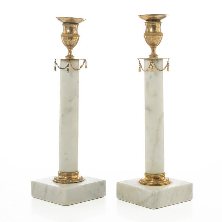 A pair of late Gustavian gilt brass and marble candlesticks, circa 1800.
