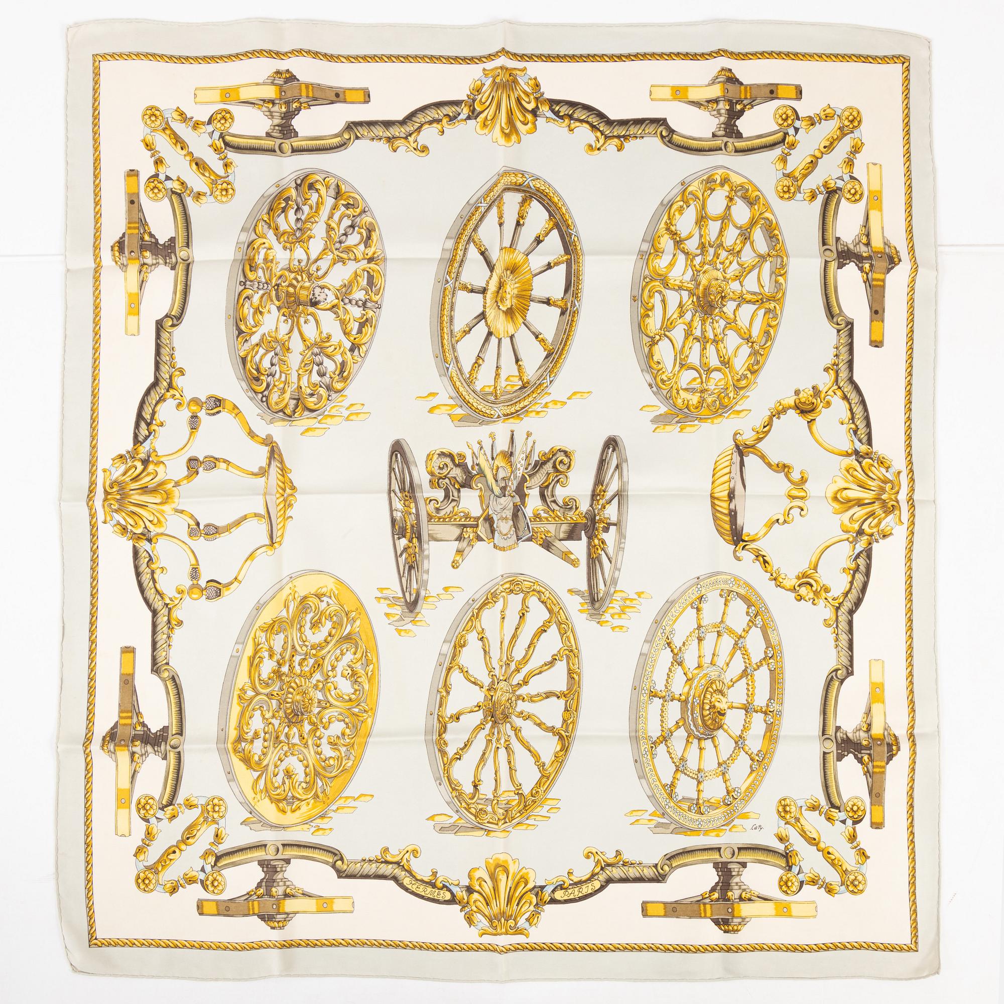 Hermès, a 'Roues de Canon' silk scarf.