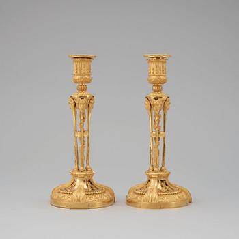 A pair of Louis XVI-style candlesticks, presumably early 20th century.