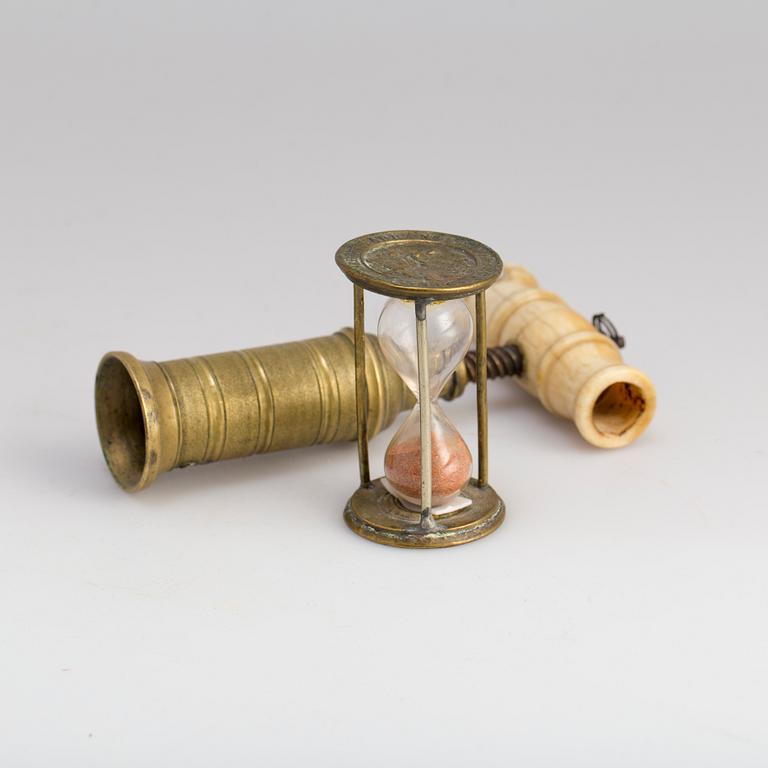 A brass cork screw and hourglass 19th century.
