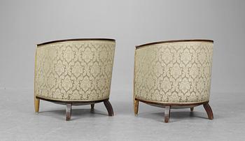 A pair of French partly gilt palisander armchairs in the manner of Poul Follot, 1920-30's.