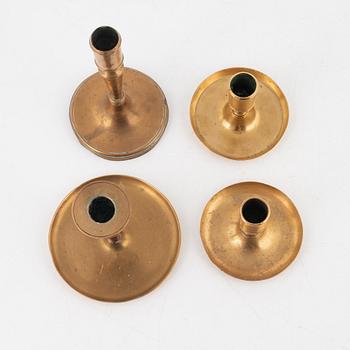 Four brass candlesticks, 18th-19th Century.