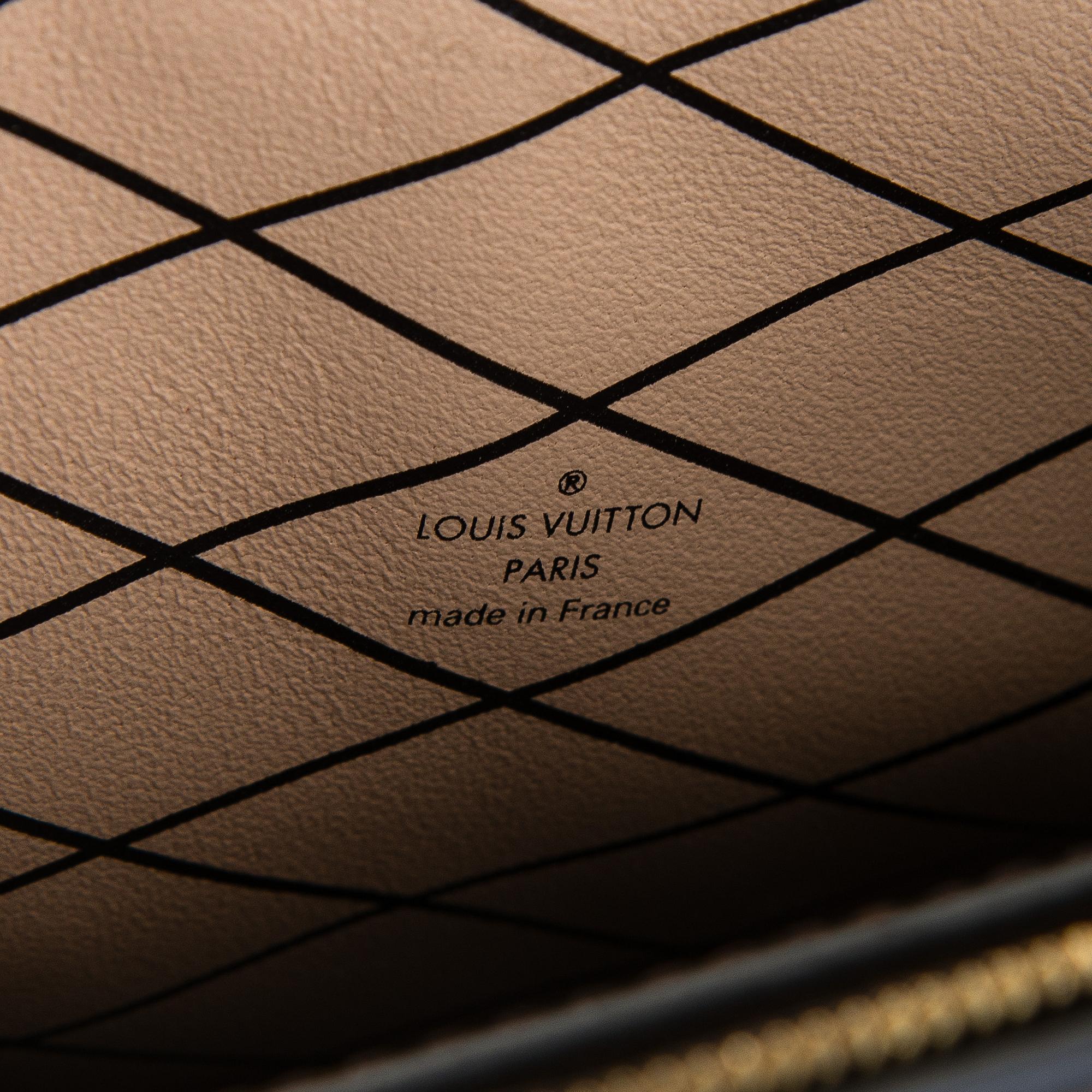 Louis Vuitton, a "Reverse Monogram Trunk Clutch" bag.