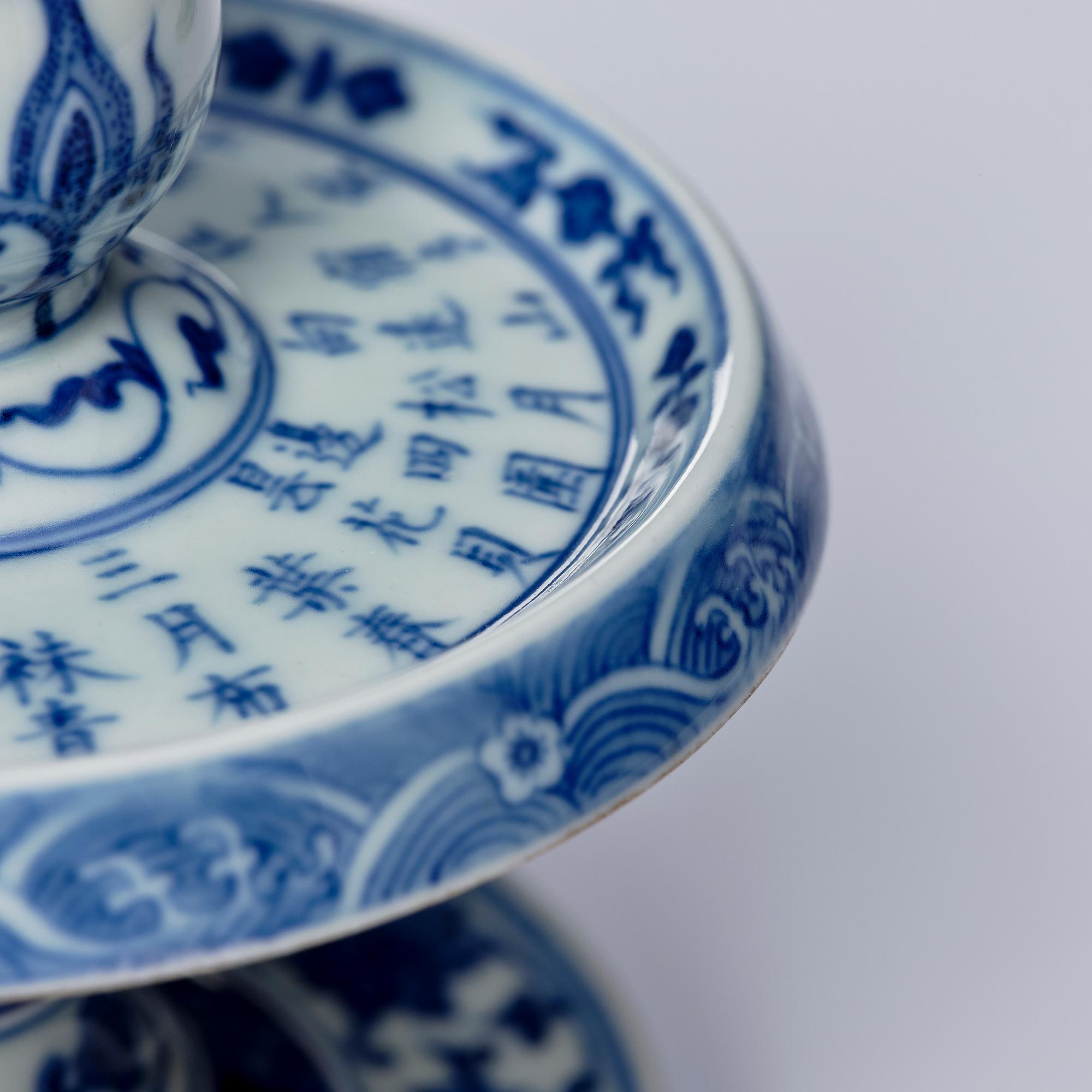 A pair of blue and white pricket candle sticks, with a poem, Qing dynasty with a Qianlong mark and of the period.