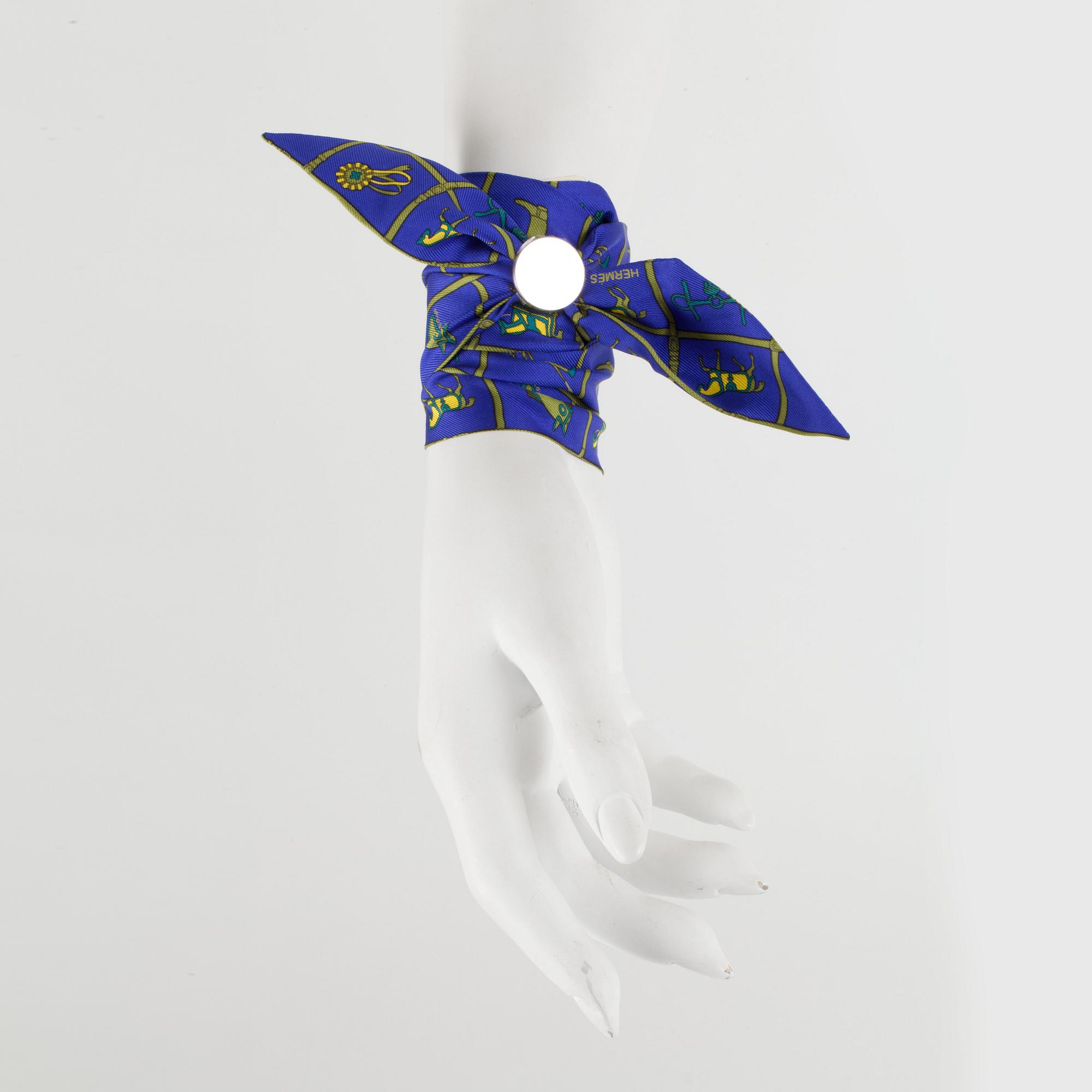 HERMÈS, two silk braclets with palladiumcovered locks.