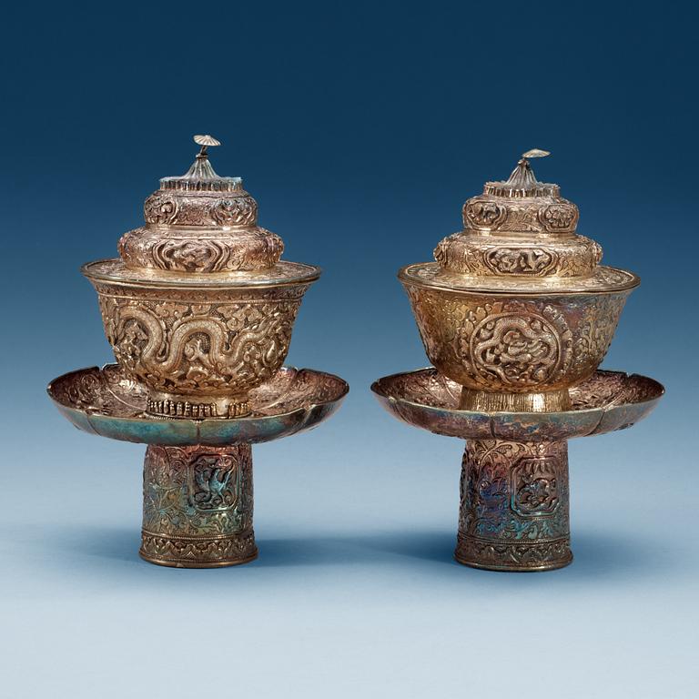 A pair of silver cups with stands and covers, Tibet/Nepal.