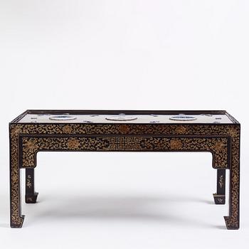 A Chinese black lacquered table with porcelain placques, presumably first half of the 20th century.