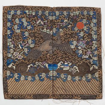 An embroidered civil official's rank badge with a bird, 'buzi', Qing dynasty.