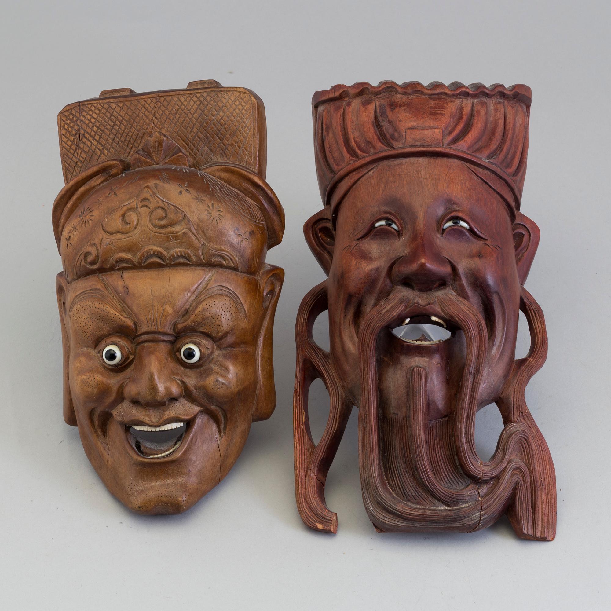 Two wooden south east asian masks, 20th century.