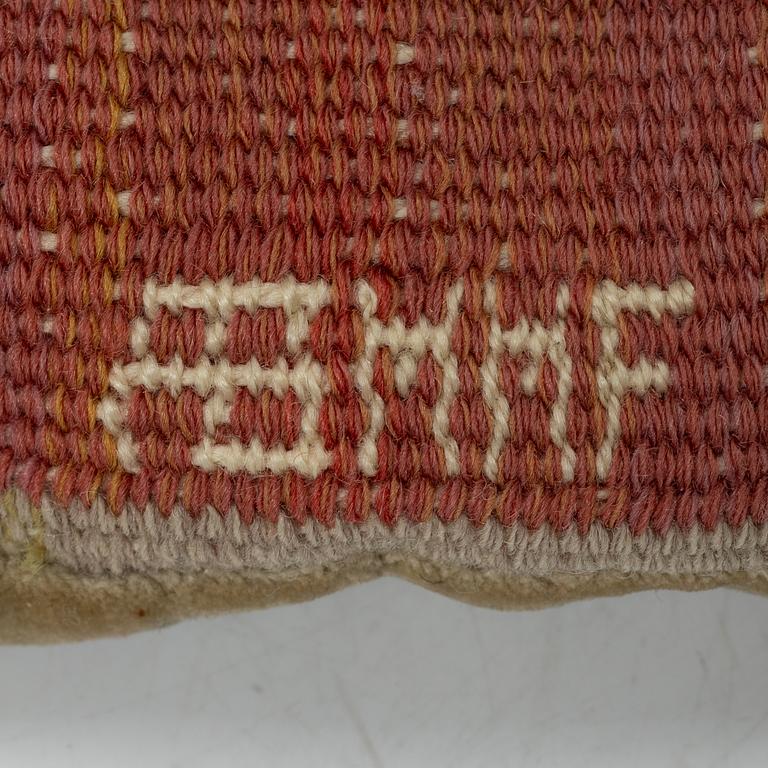 Märta Måås-Fjetterström, a cushion, 'Blommor på röd botten', signed AB MMF, ca. 31 x 31 cm.
