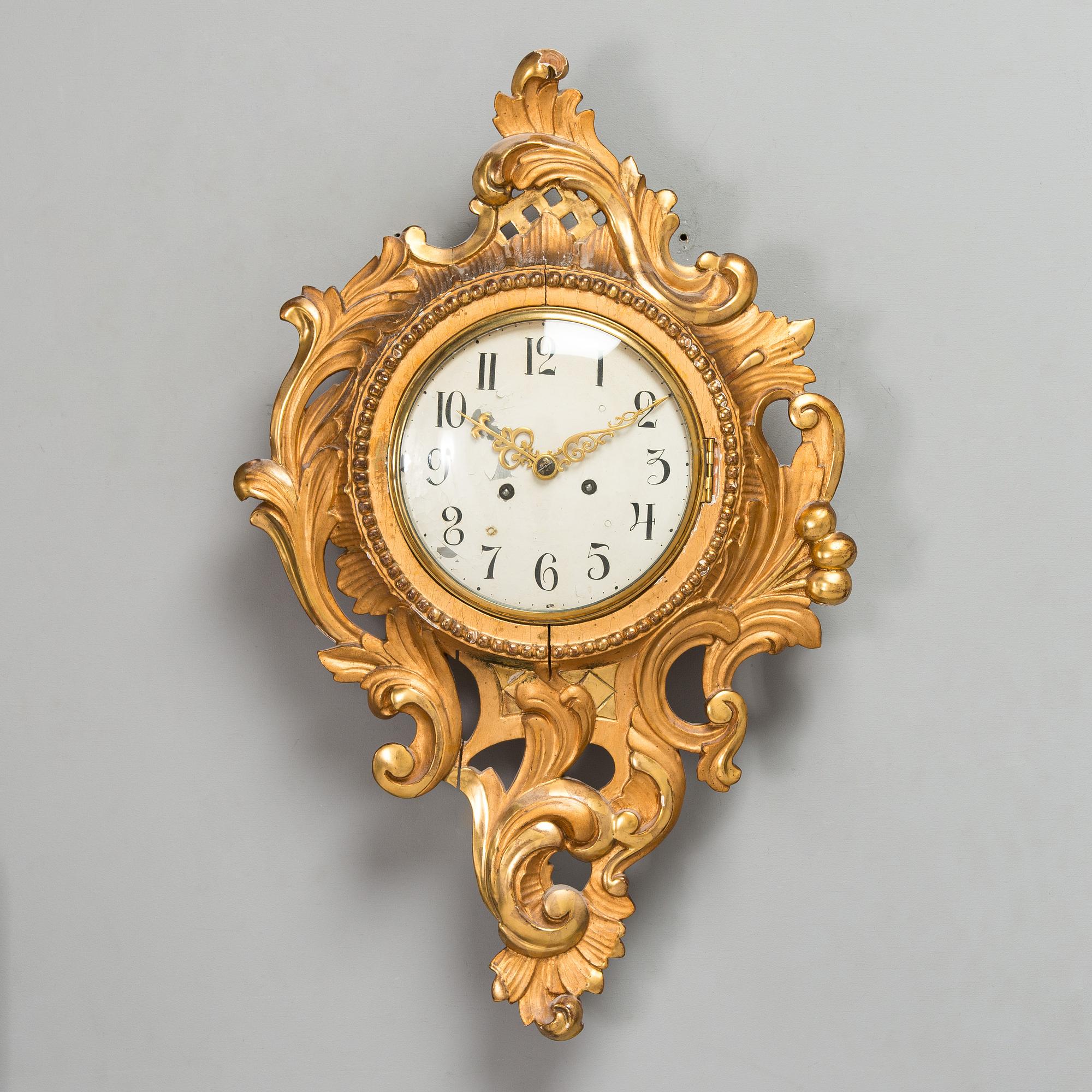 A Rococo style wall clock from first half of the 20th century.