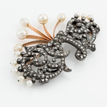 An 18K gold and silver brooch with rose-cut diamonds and pearls.