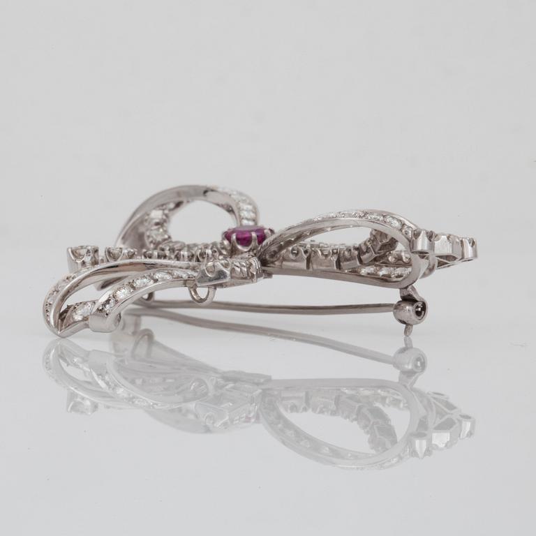 A brilliant- and baguette- cut diamond and ruby brooch.