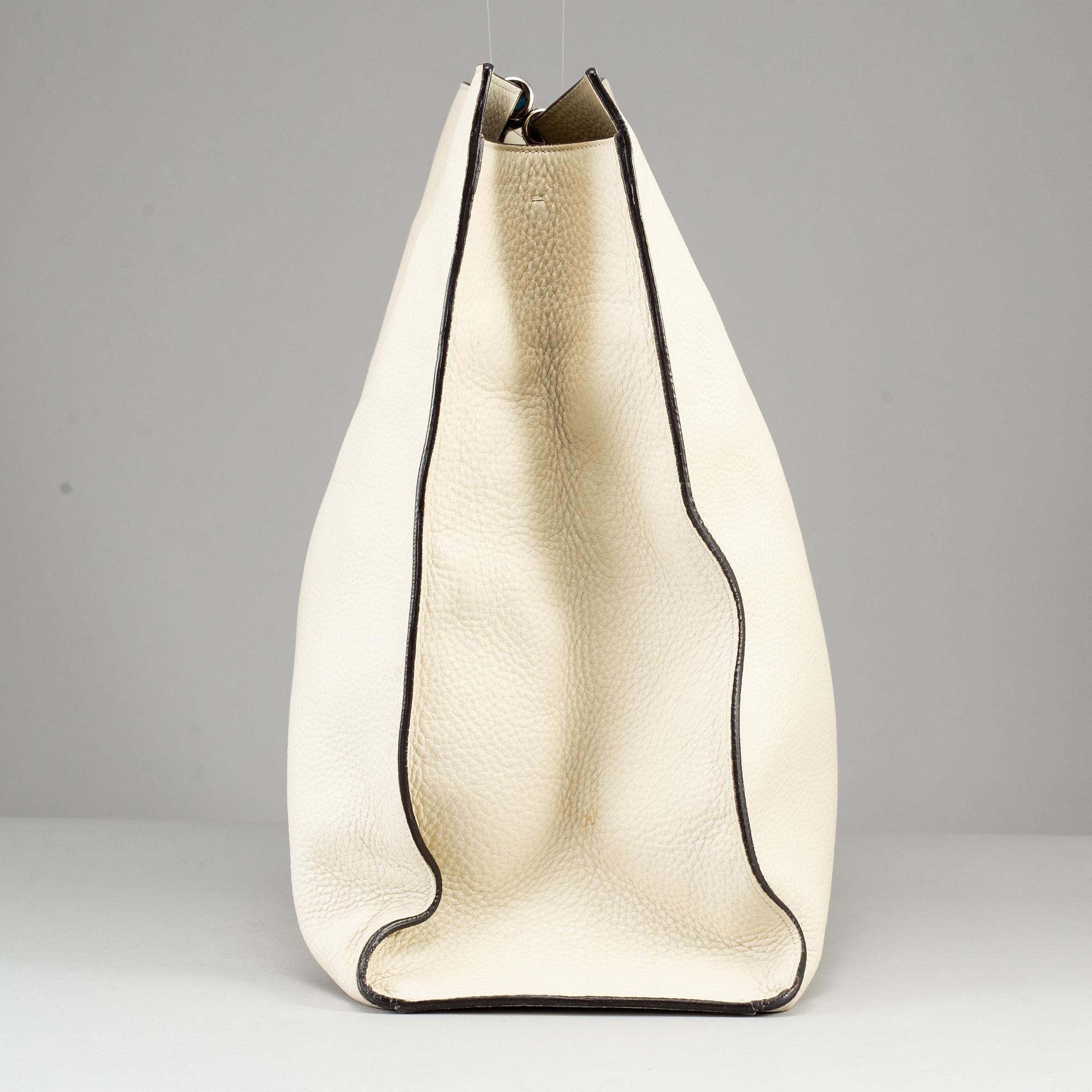 GUCCI, a white leather tote bag with bamboo handles.