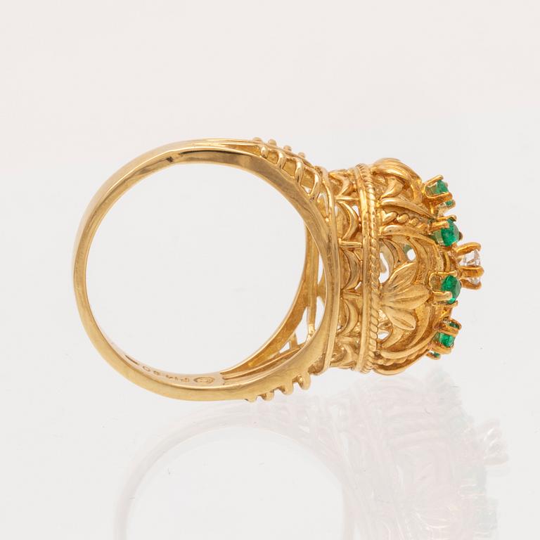 An 18K gold ring set with a round brilliant cut diamond and round single cut emeralds by Franklin Mint 1980.