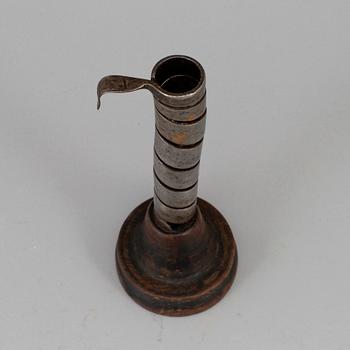 An 18th century wood and iron candlestick.