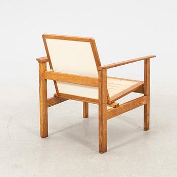 A stained wooden armchair later part of the 20th century.