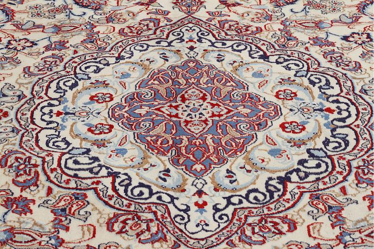 A Nain rug, part silk, 390 x 287 cm.