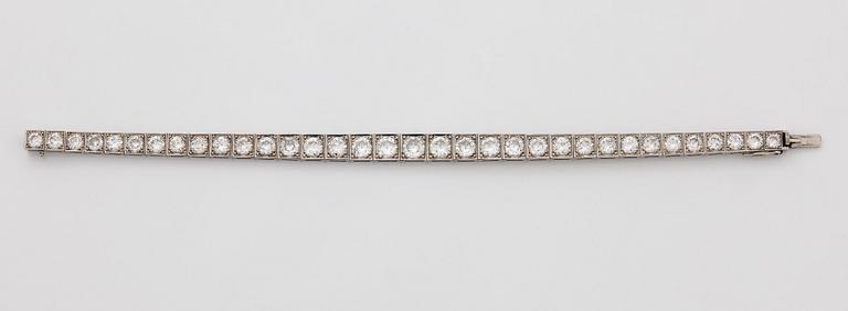 A platinum bracelet set with round brilliant-cut diamonds.