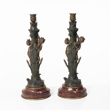 a pair of bronze and marble candle sticks, after a model by Houdon, late 19th century.