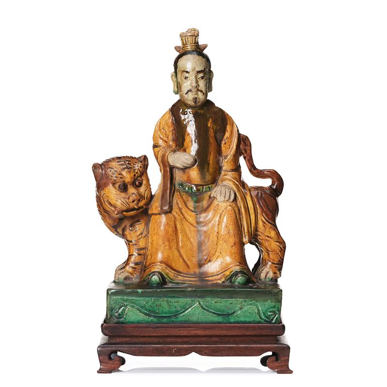 A green and yellow glazed figure of a dignitary and a tiger, Ming dynasty (1368-1644).