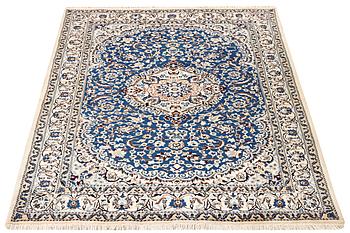 A Nain carpet, part silk, 9 laa, c. 300 x 189 cm.