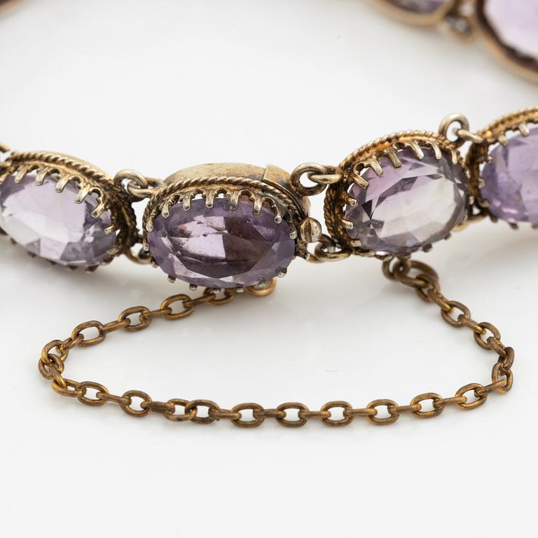 Garniture, necklace and bracelet silver with amethysts, brooch gold-coloured metal with purple paste stones,