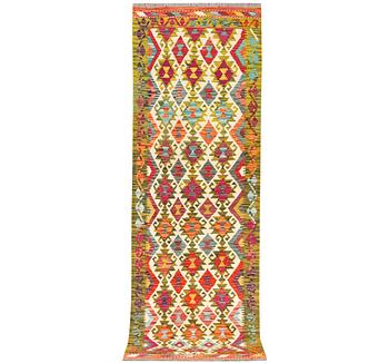 An Afghan kilim rug, c. 246 x 80 cm.