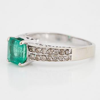 An emerald and  brilliant cut diamond ring.