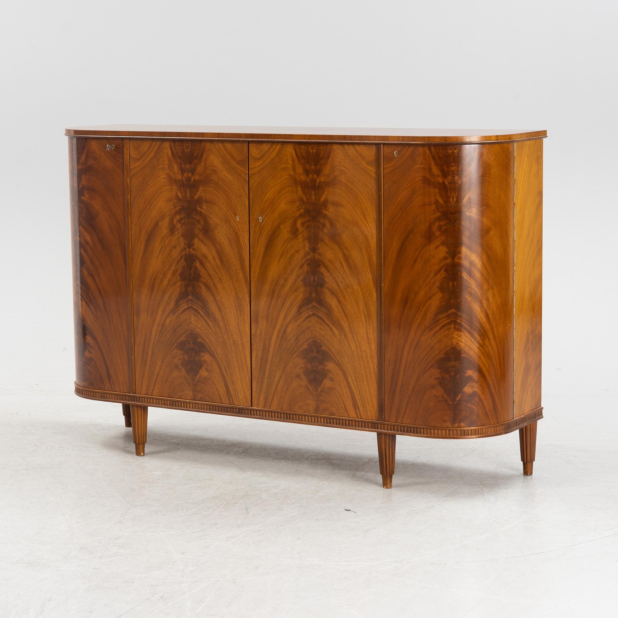 A 1940s mahogany veneered cabinet.