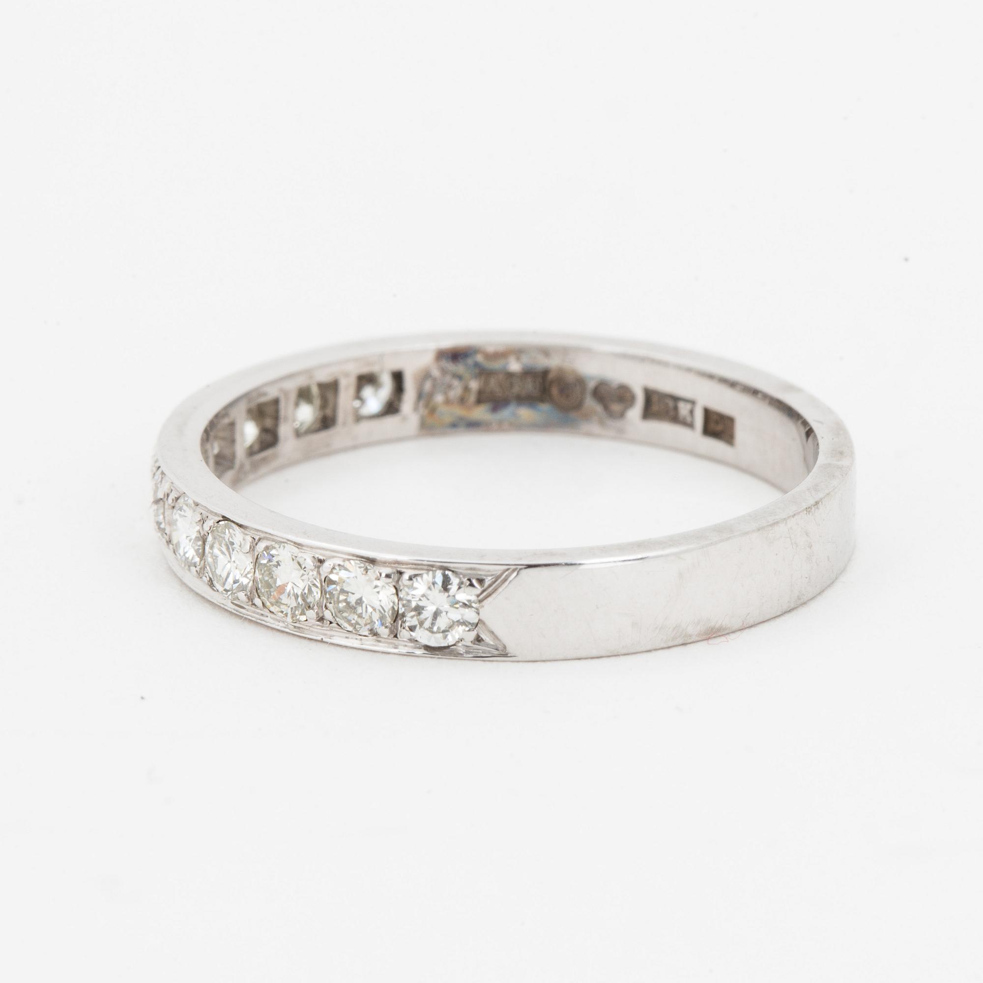 Brilliant-cut diamond half-eternity ring.