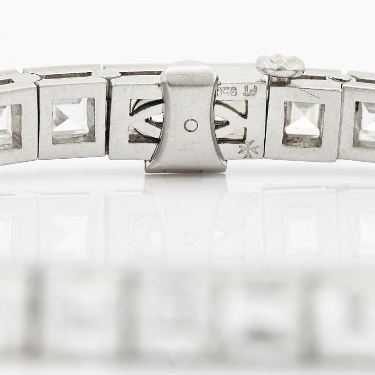 A platinum bracelet set with carré cut diamonds.