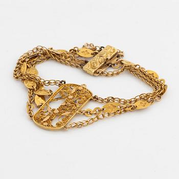 An 18K gold bracelet.