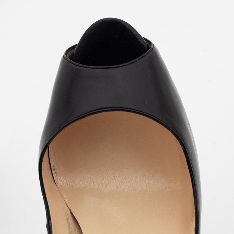 Christian Louboutin, a pair of black leather peep toe pumps, size 37 1/2.