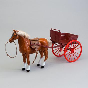 A plastic doll's house with six dolls, furniture and clothes, 20th century.