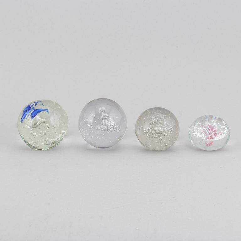 A group of 12 glass paper weights.