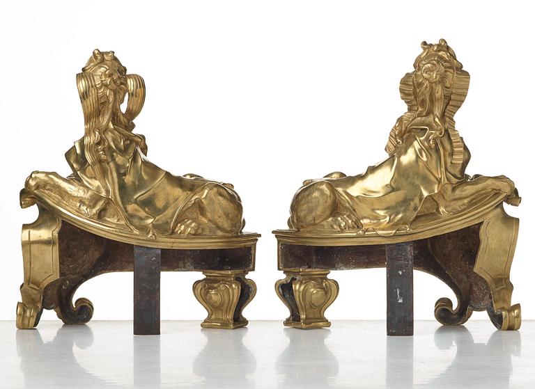 A pair of Louis XV fire dogs, France, mid 18th century, the design of the sphinxes attributed Nicolas Coustou 1658-1733.