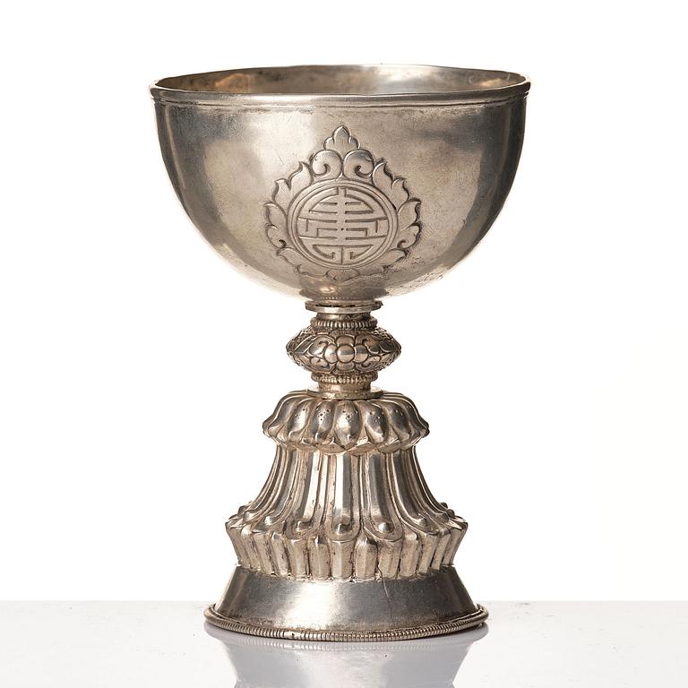 A Tibetan butter lamp, silvered copper, 20th century.