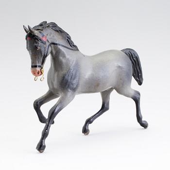 A painted tinplate toy horse ca year 1900.