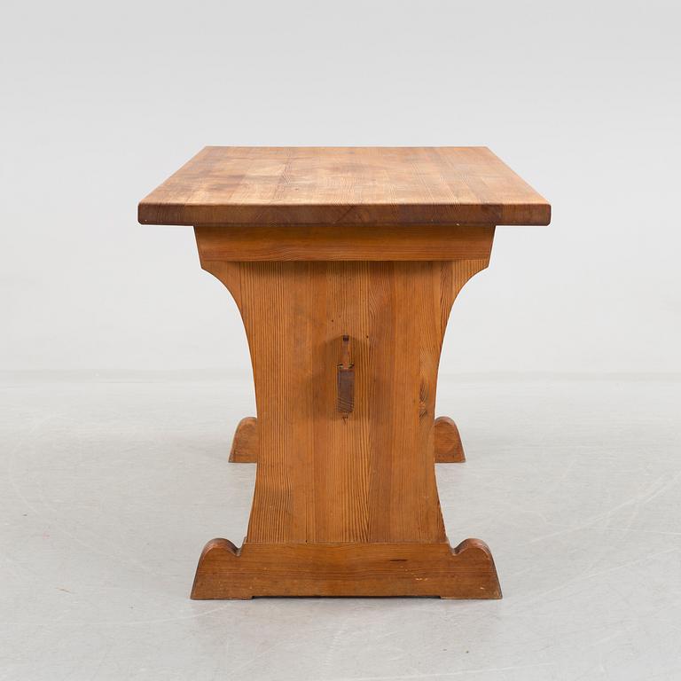 A solid pine table attributed to Axel Einar Hjort.