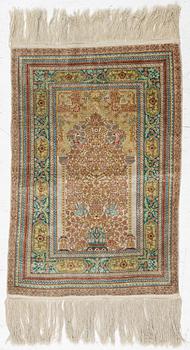 A semi-antique silk Hereke, c. 92 x 61 cm.