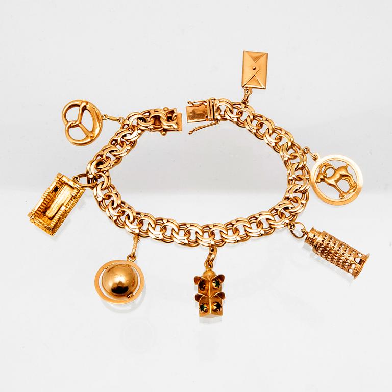 An 18K gold bracelet with charms.