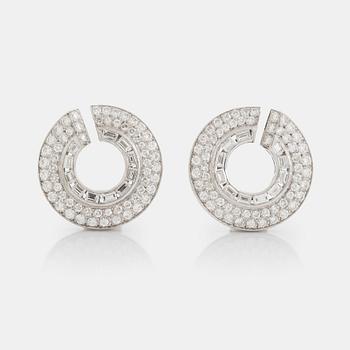 508. A pair of 14K gold earrings set with round brilliant- and baguette-cut diamonds.